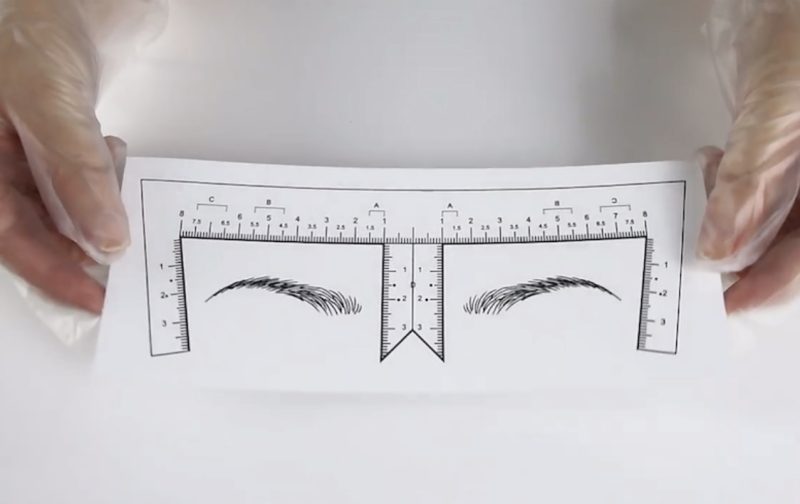 Disposable measuring sticker for eyebrow mapping.